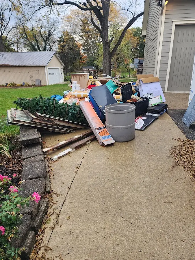 Dumpster being loaded with debris for Estate Cleanout Dumpster Rental in Goshen